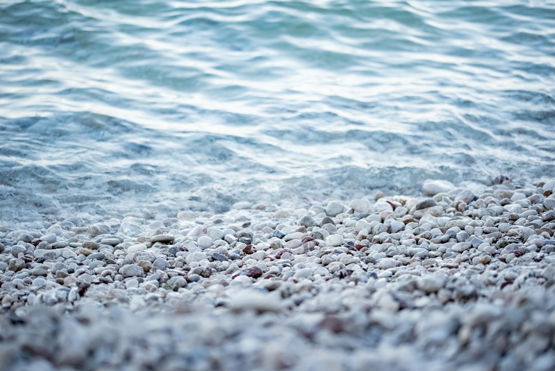 crystal clear sea pebble beach